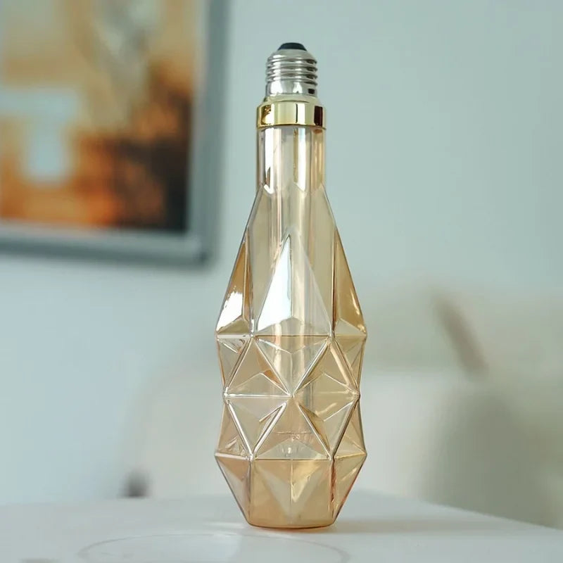 D78-Edison-bulb-with-diamond-cut-amber-glass-glowing-warmly